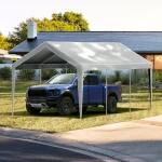 Carport canopy sheltering a blue truck in a residential driveway